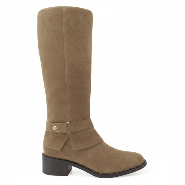 A tall brown suede knee-high boot with a low block heel and a decorative strap detail on the ankle, shown against a white background with a 'Genuine Leather' graphic in the top right corner.