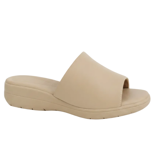 A single beige slide sandal with a wide, open-toe strap and a low, chunky platform sole, shown from a side profile on a white background.