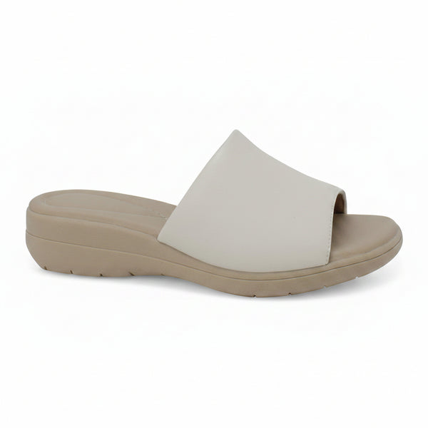 A single slide sandal with a wide, flat strap in a light off-white color and a thick, low-profile wedge sole in a warm taupe-beige, shown from a side profile view against a plain white background.