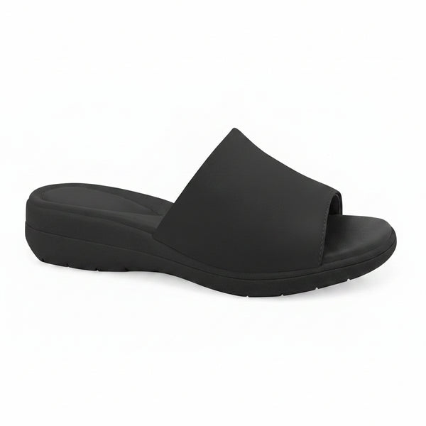 A single black slide sandal with a wide, padded upper strap and a thick, cushioned wedge sole, shown from a side profile on a white background.