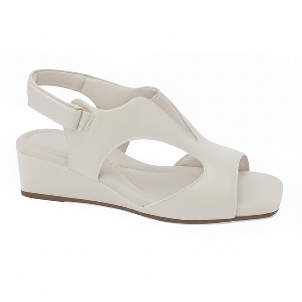 A white wedge sandal with cutout details and an ankle strap, shown from a side profile on a white background. A graphic badge in the top right corner reads 'GENUINE LEATHER'.