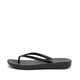 FitFlop iQushion All Black flip-flop, side view showing toe-post straps and textured footbed
