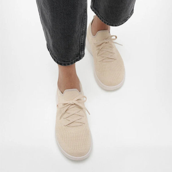 FitFlop Super-Q Paris Beige knit laced sneakers worn with cropped dark jeans.