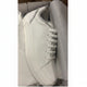 A white leather sneaker with silver glitter trim along the collar and white laces, resting inside its white shoebox with white tissue paper.