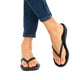 FitFlop iQushion All Black flip-flops worn with blue jeans