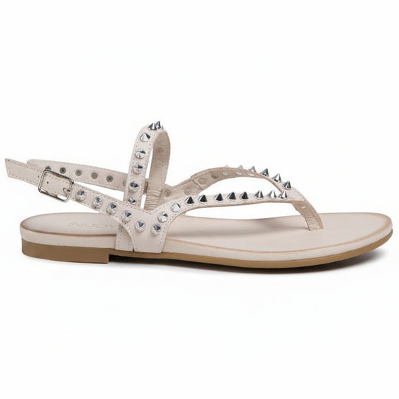 Inuovo 101105 bone flat leather sandal with studded straps and adjustable ankle strap.