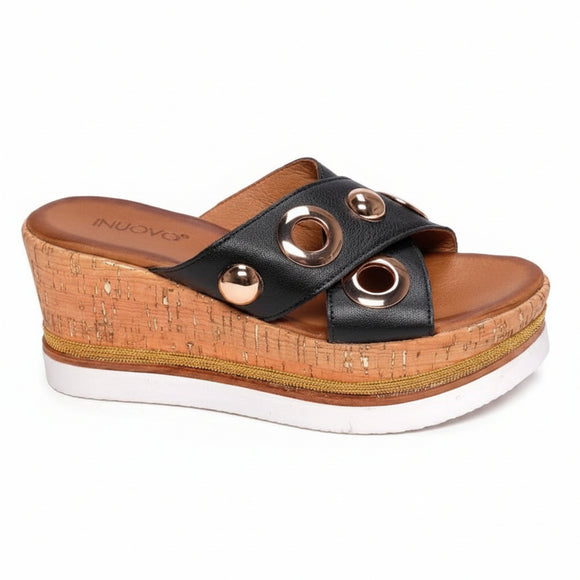 Inuovo 8790 black leather slip-in wedge with cork sides, studded straps and gold eyelets.