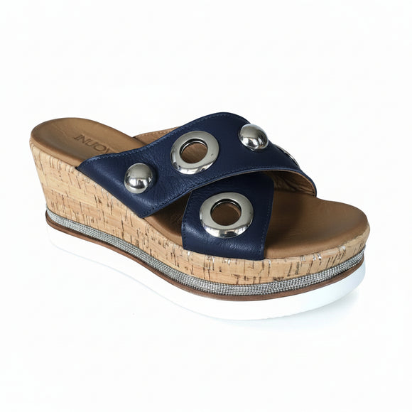 Inuovo 8790 navy leather slip-in wedge with cork sides, studded straps and silver eyelets.